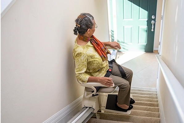 Harmar Pinnacle SL300 Stair Lift Taking Woman with Limited Mobility up a Staircase Product Image