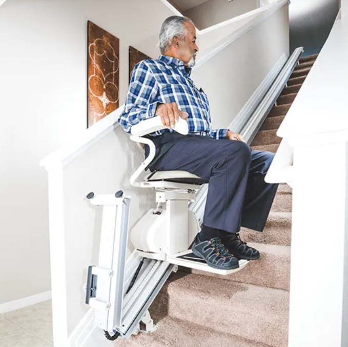 Harmar Pinnacle SL300 Stair Lift with Folding Rail Taking a Man Up the Stairs Product Image