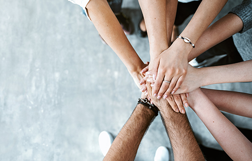 hands in to display teamwork